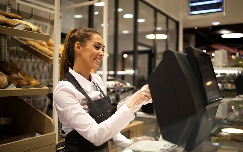 Bakery worker using POS at the counter