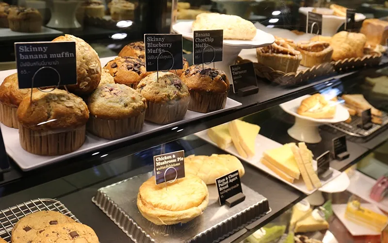 Bakery chef using a tablet behind the counter