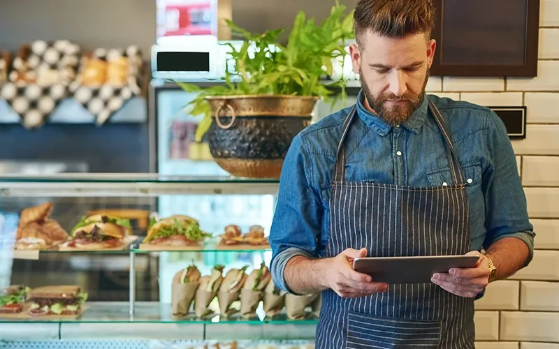 Waiter checking inventory on tab
