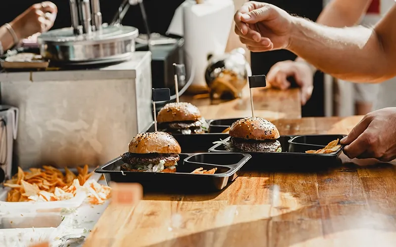 Multiple burgers served on table