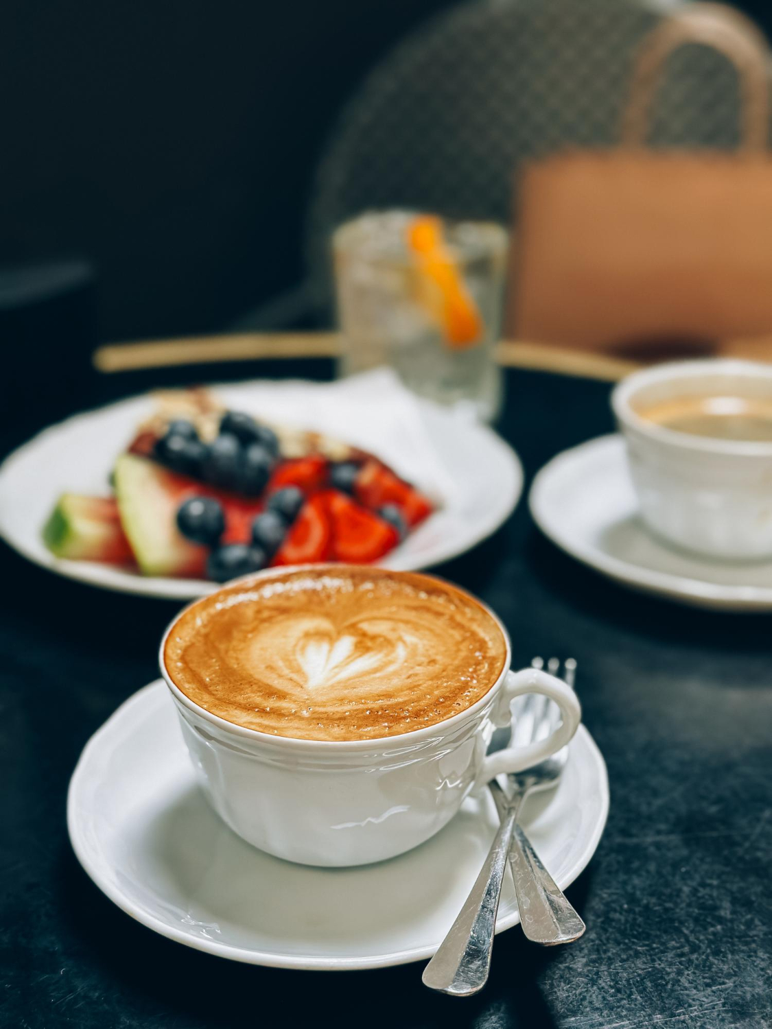A cafe counter with a store manager adjusting pricing